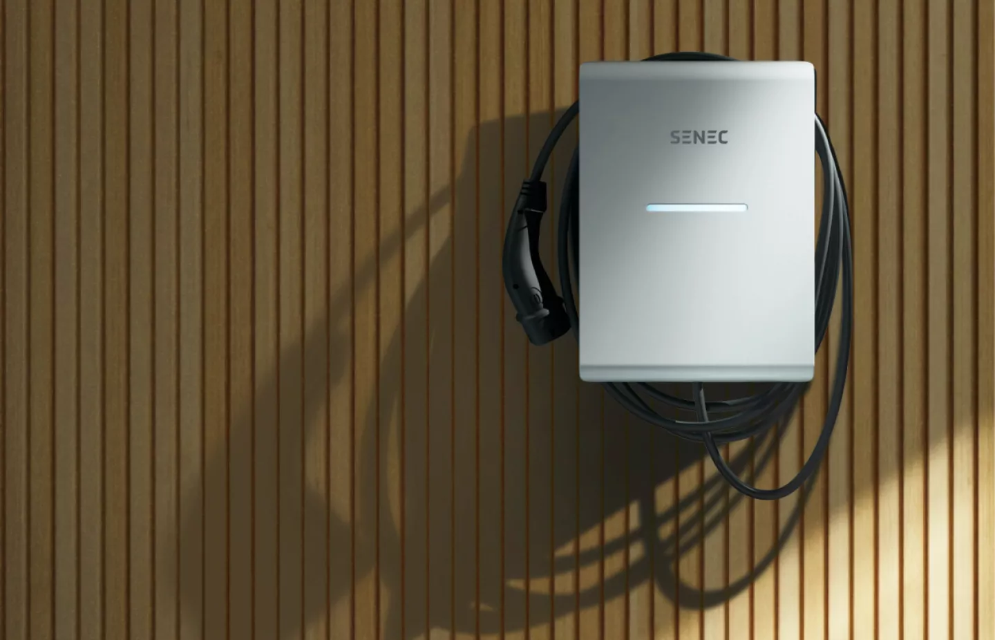 SENEC.Wallbox pro on a wooden wall