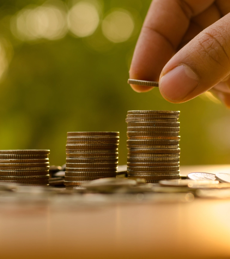 Person stacks coins